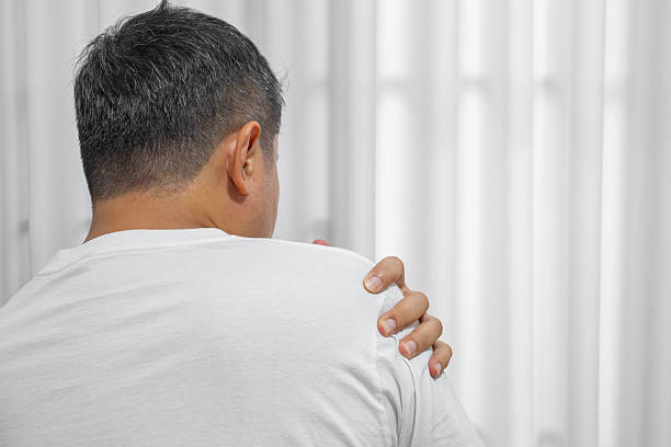 Image of man pressing his shoulder