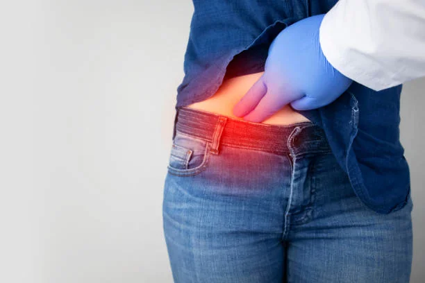 a doctor with a blue glove chhecking a man's lower stomach